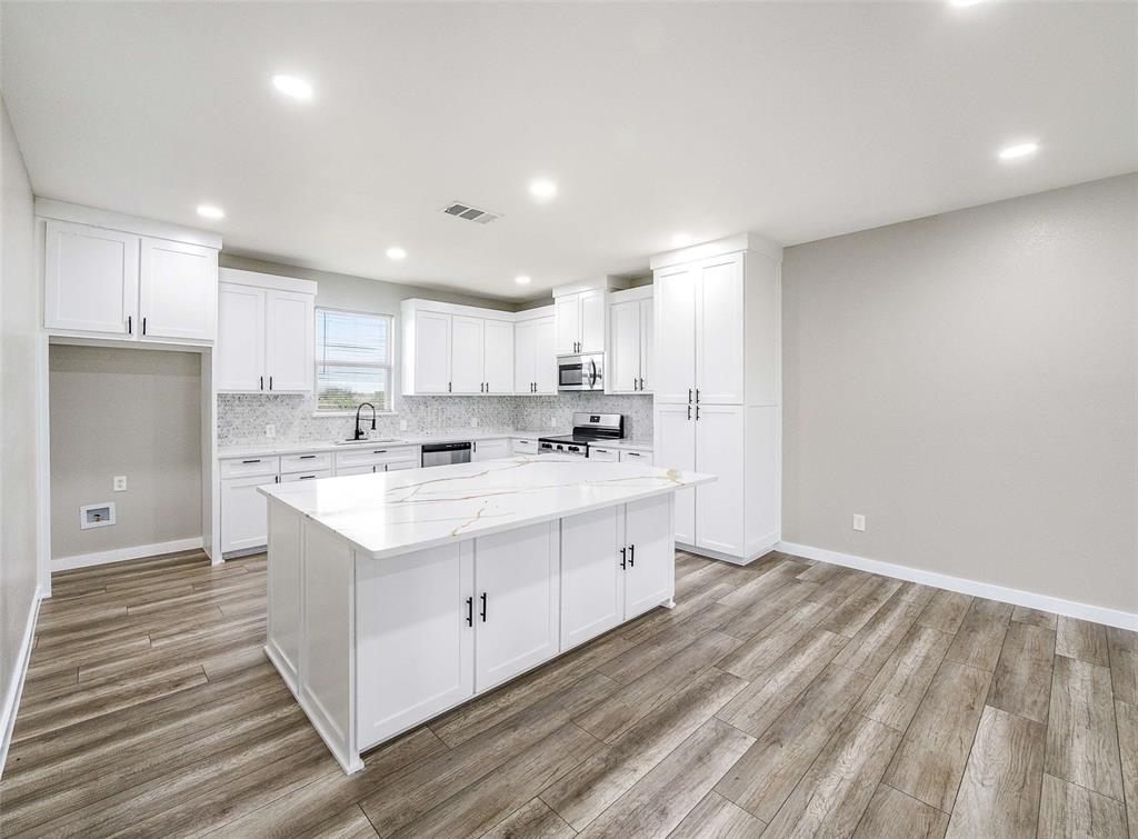 1061 Zmolek Road Ennis, TX 75119 - Photo 9 of 40 a kitchen with a sink stainless steel appliances and cabinets