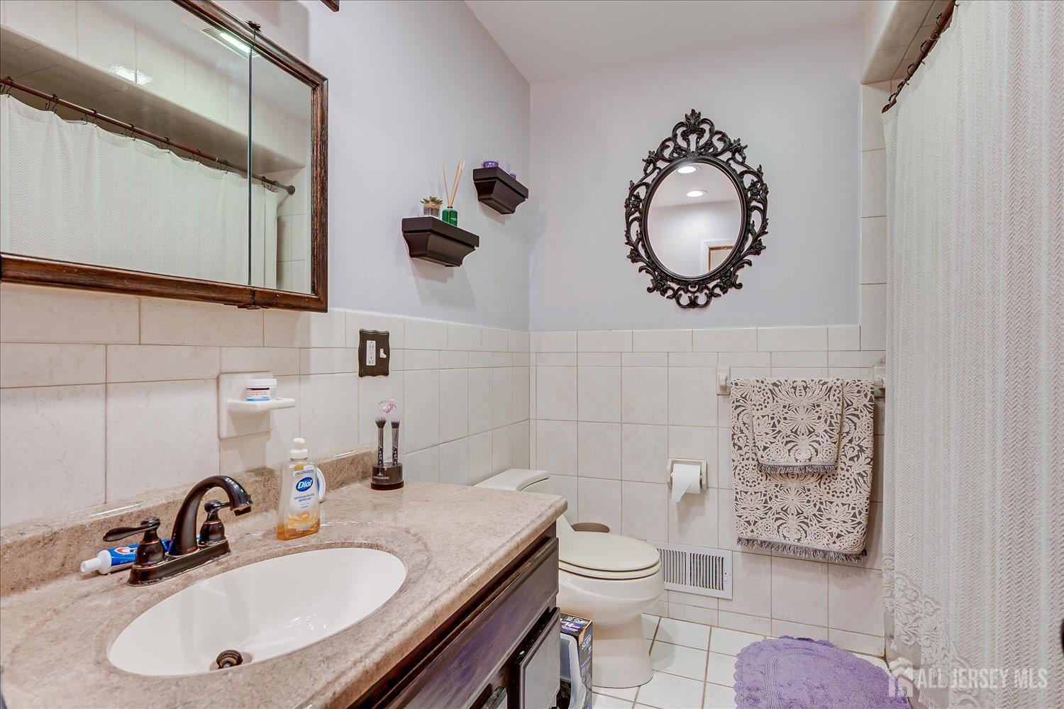 12 Gales Road Edison, NJ 08837 - Photo 23 of 35 a bathroom with a toilet a sink and mirror