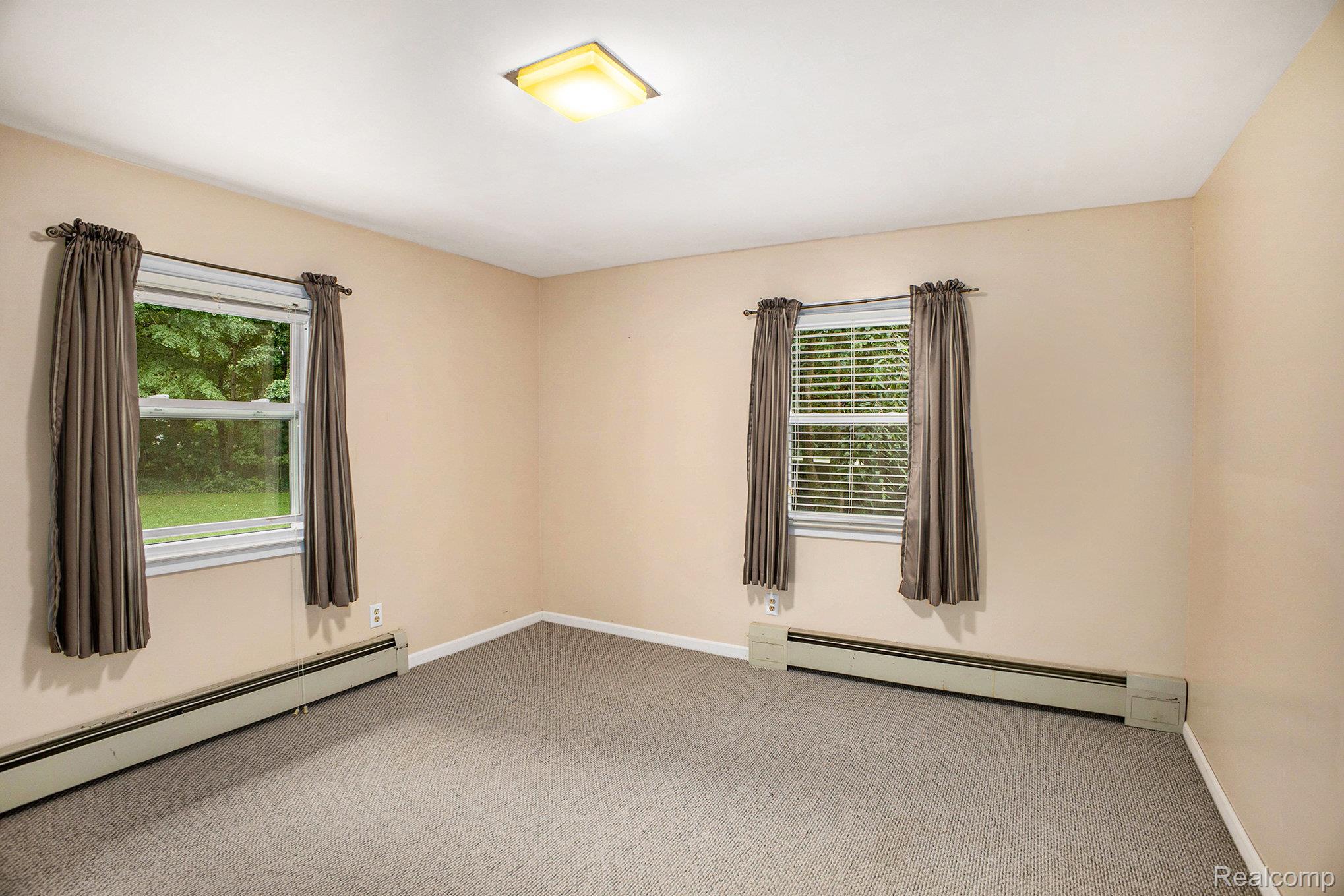 16568 28 Mile Road Albion, MI 49224 - Photo 13 of 26 Carpeted empty room featuring a baseboard heating unit