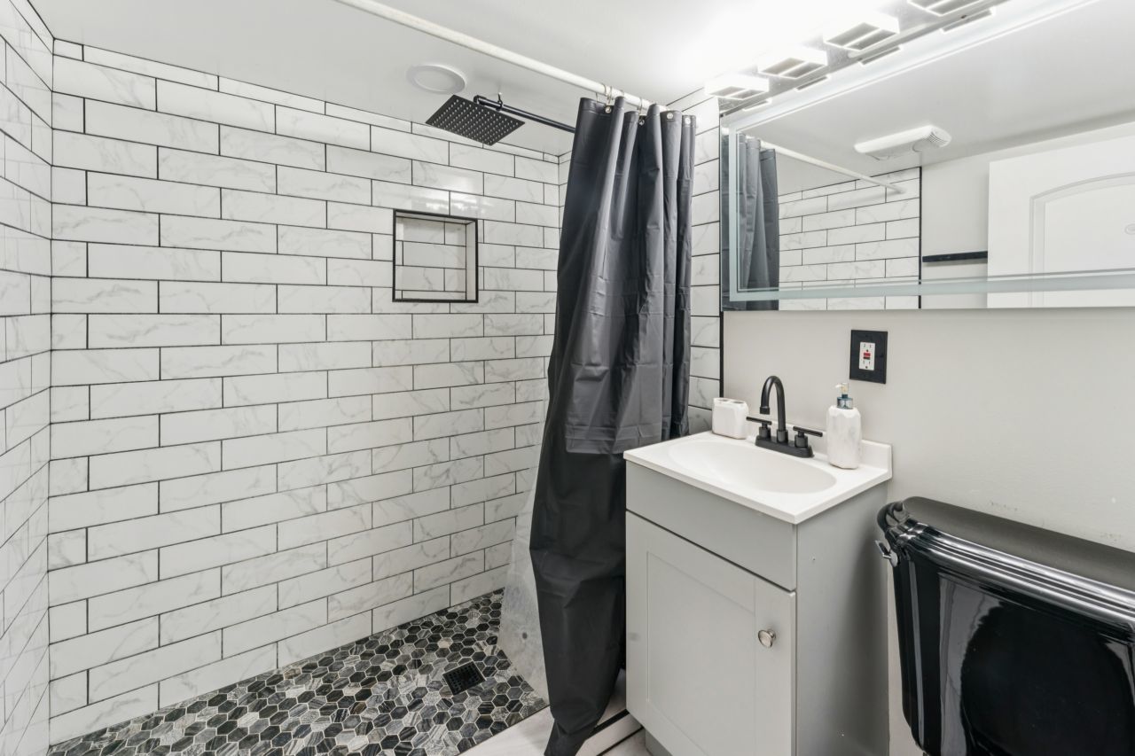 2547 Davisson Street River Grove, IL 60171 - Photo 16 of 31 a bathroom with a sink a toilet and shower