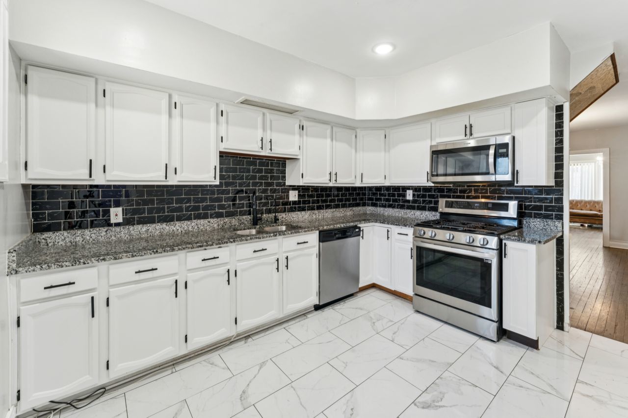 2547 Davisson Street River Grove, IL 60171 - Photo 6 of 31 a kitchen with granite countertop white cabinets and stainless steel appliances