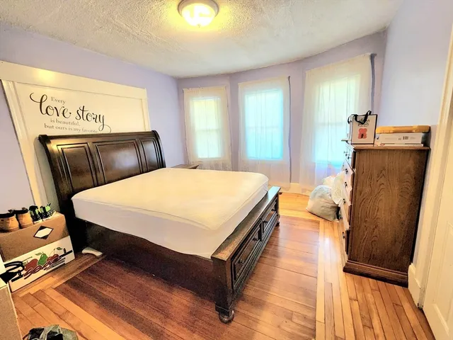 a bed sitting in a room next to a window