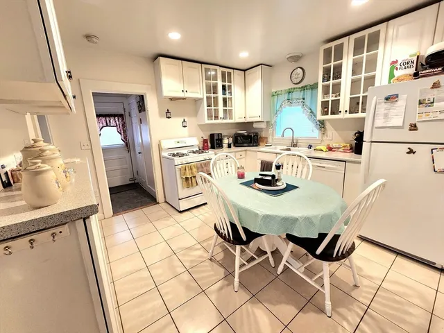 a kitchen with stainless steel appliances kitchen island granite countertop a sink and cabinets