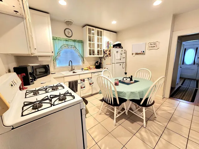 a kitchen with stainless steel appliances a stove a sink and a refrigerator