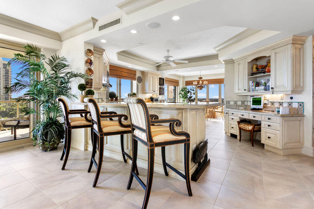 3920 North Ocean Drive, Unit 6A Singer Island, FL 33404 - Photo 11 of 71 a kitchen with stainless steel appliances kitchen island granite countertop table chairs and a refrigerator