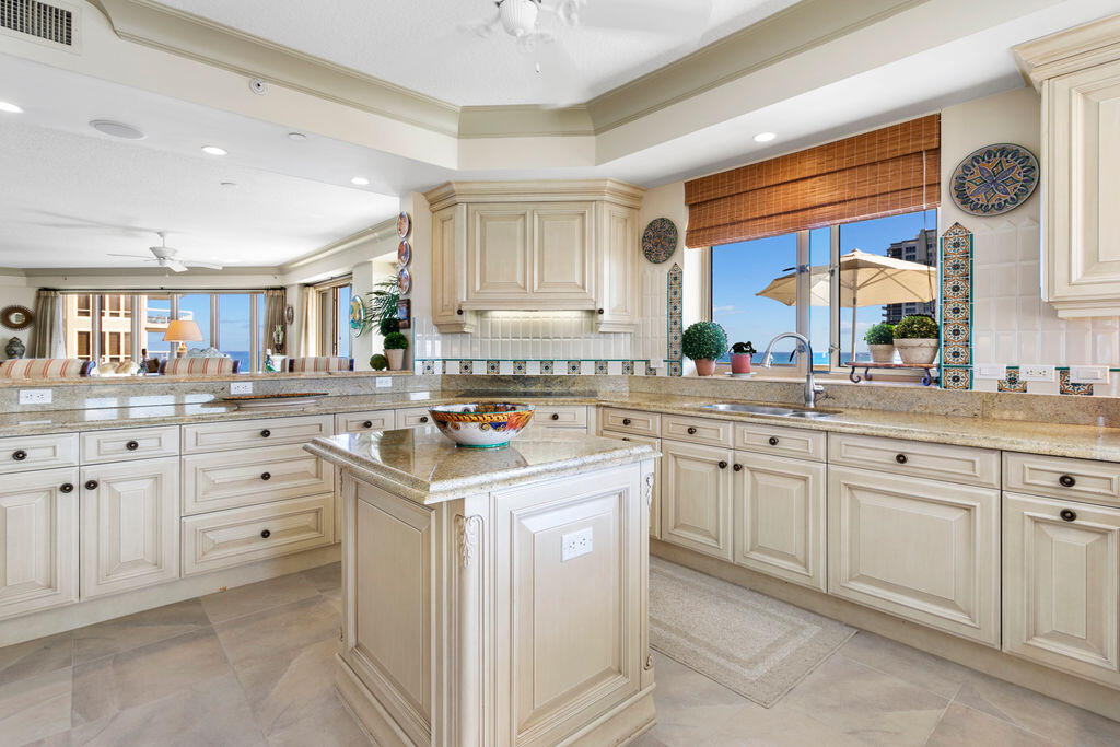 3920 North Ocean Drive, Unit 6A Singer Island, FL 33404 - Photo 13 of 71 a kitchen with cabinets appliances a sink and a window