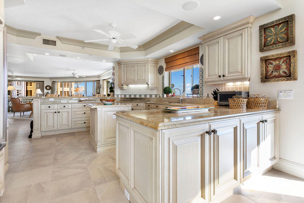 3920 North Ocean Drive, Unit 6A Singer Island, FL 33404 - Photo 14 of 71 a kitchen with stainless steel appliances granite countertop a stove top oven a sink dishwasher and a refrigerator