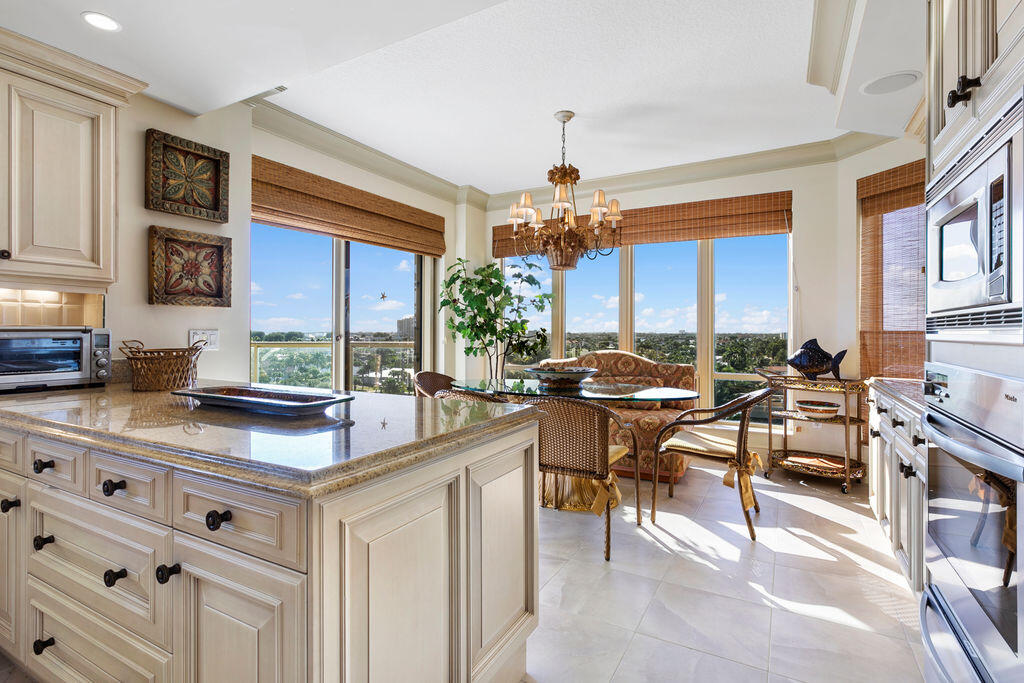 3920 North Ocean Drive, Unit 6A Singer Island, FL 33404 - Photo 15 of 71 a room with stainless steel appliances kitchen island granite countertop a table chairs sink and cabinets