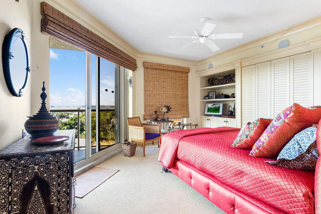 3920 North Ocean Drive, Unit 6A Singer Island, FL 33404 - Photo 30 of 71 a bedroom with a bed a chandelier and large window