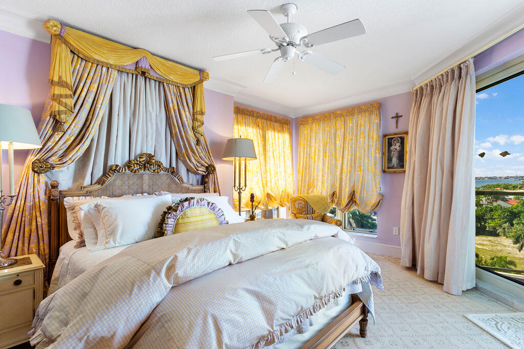 3920 North Ocean Drive, Unit 6A Singer Island, FL 33404 - Photo 34 of 71 a bedroom with a bed and a chandelier