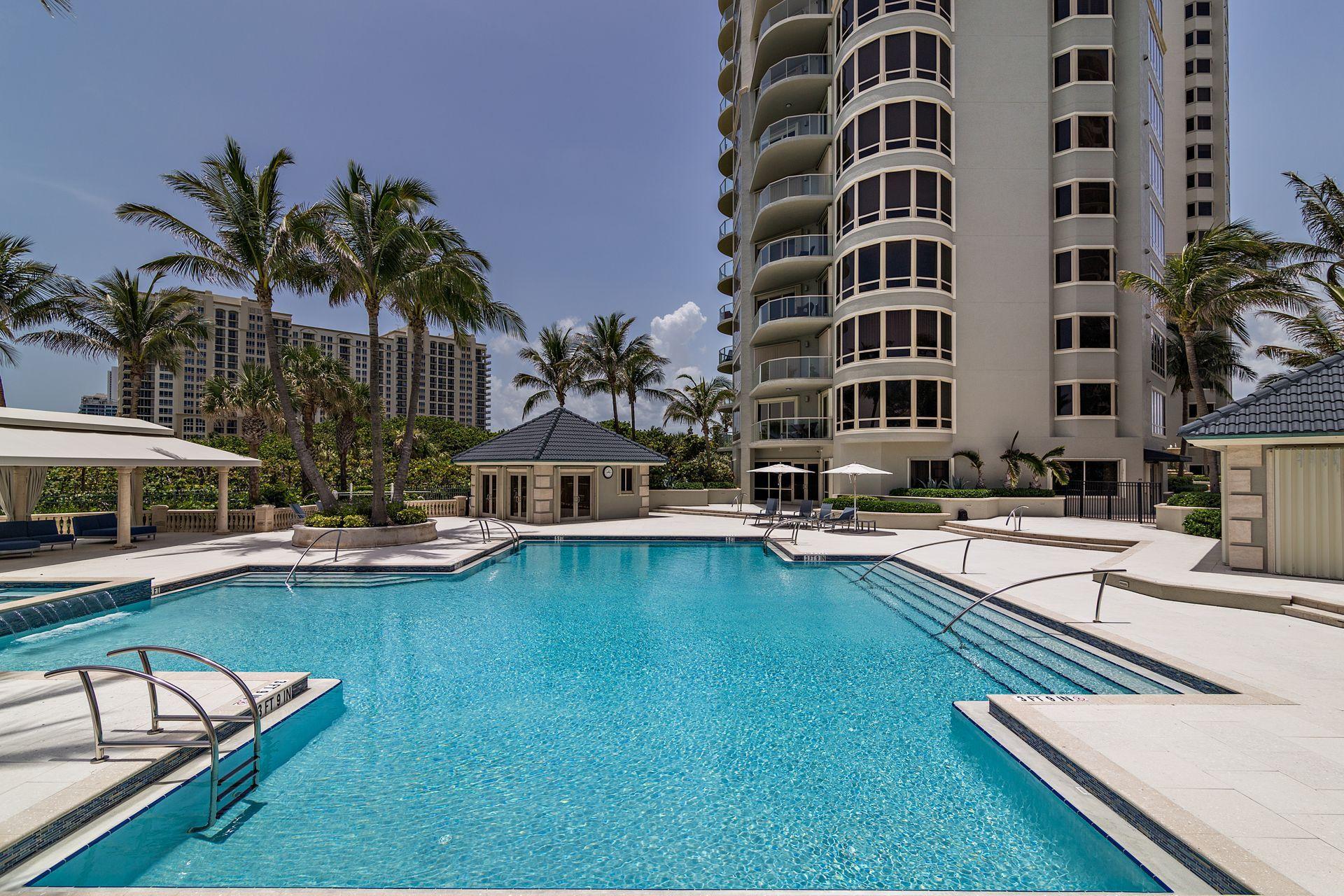 3920 North Ocean Drive, Unit 6A Singer Island, FL 33404 - Photo 39 of 71 a swimming pool with outdoor seating and yard