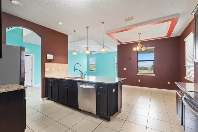 a kitchen with stainless steel appliances granite countertop a sink counter space cabinets and stainless steel appliances