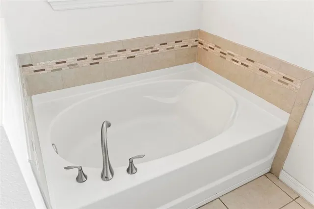 an aerial view of a house with a garden and trees