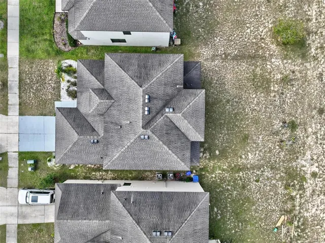 an aerial view of residential houses with outdoor space