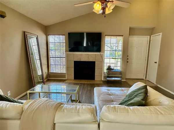 a living room with furniture flat screen tv and a fireplace
