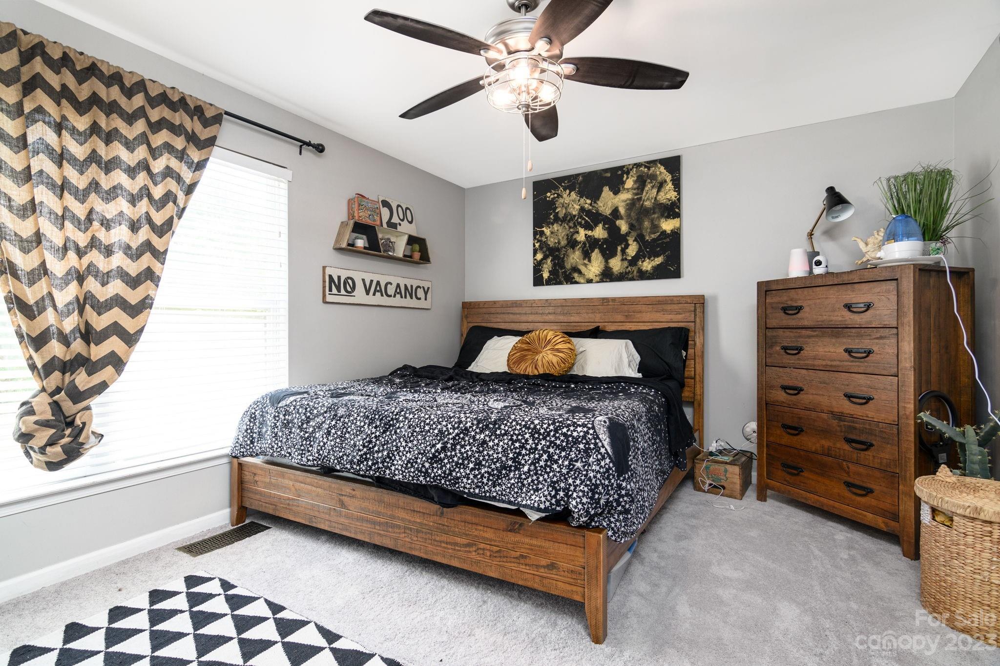 615 Raphael Place Charlotte, NC 28205 - Photo 11 of 20 a bedroom with a bed and a chandelier