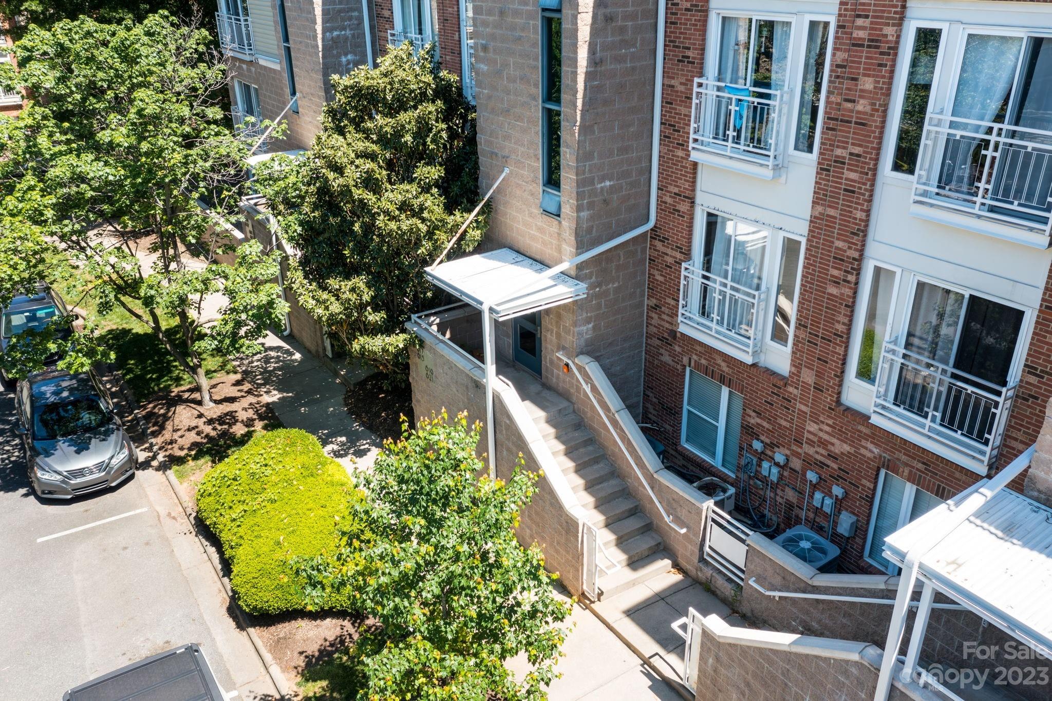 615 Raphael Place Charlotte, NC 28205 - Photo 18 of 20 a pathway of a house with a yard and potted plants