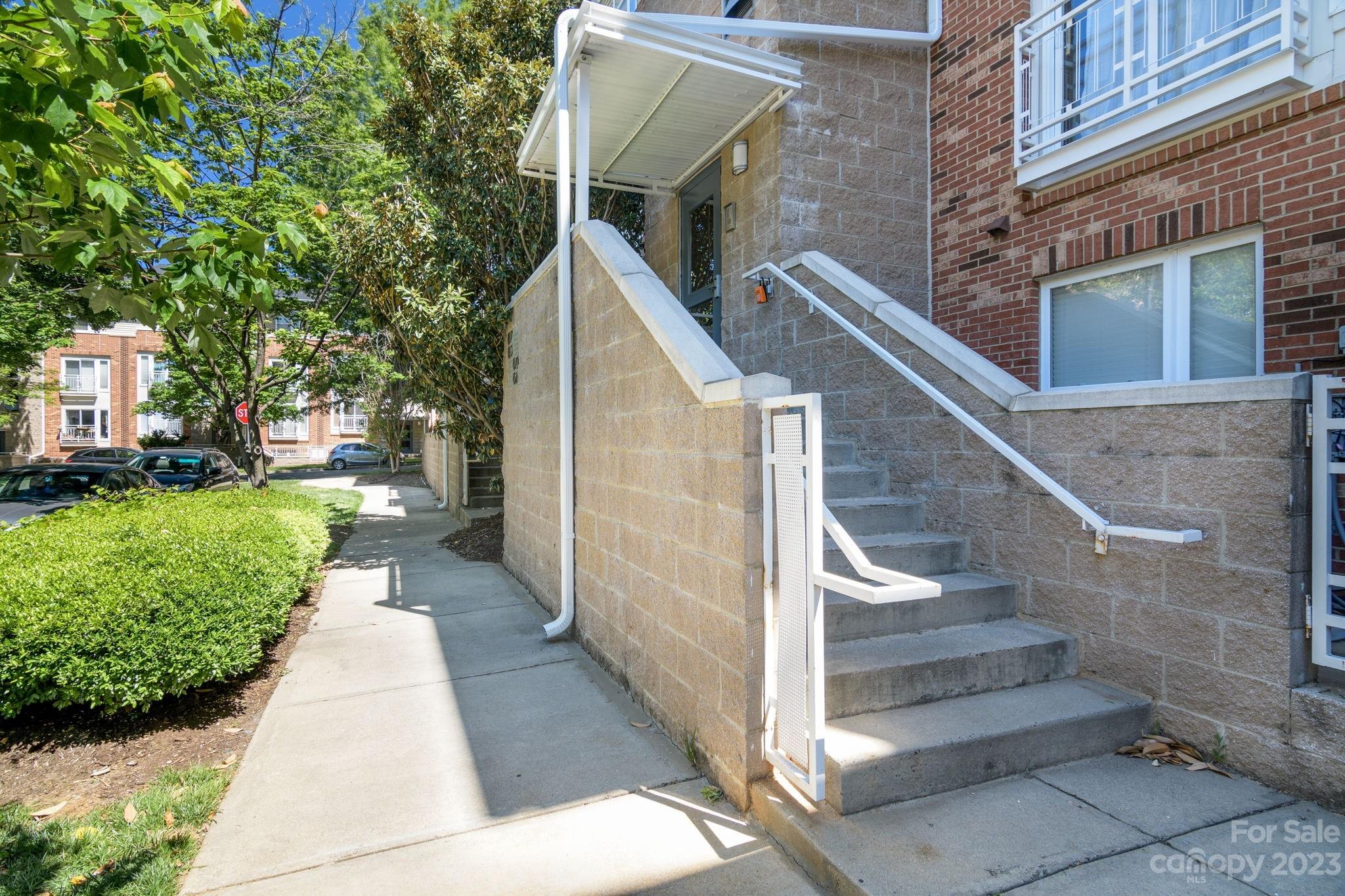 615 Raphael Place Charlotte, NC 28205 - Photo 2 of 20 a view of a pathway with a white house
