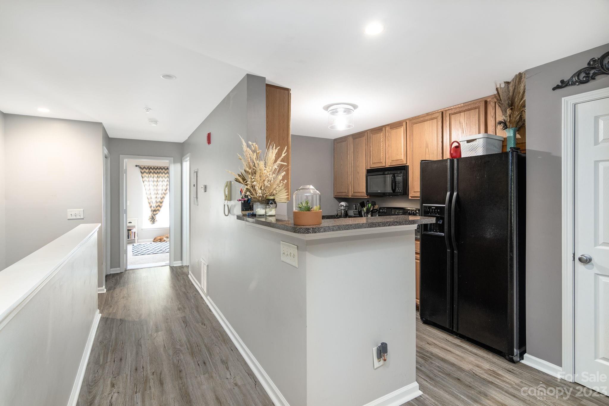 615 Raphael Place Charlotte, NC 28205 - Photo 6 of 20 a kitchen with stainless steel appliances a refrigerator and microwave