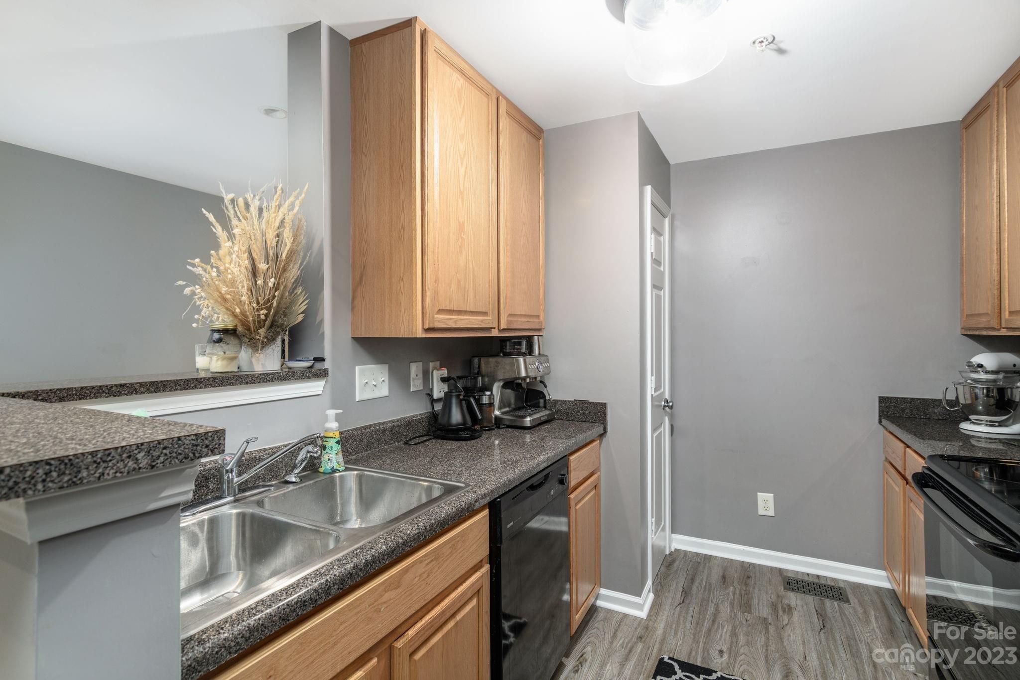615 Raphael Place Charlotte, NC 28205 - Photo 7 of 20 a kitchen with a sink and a stove top oven
