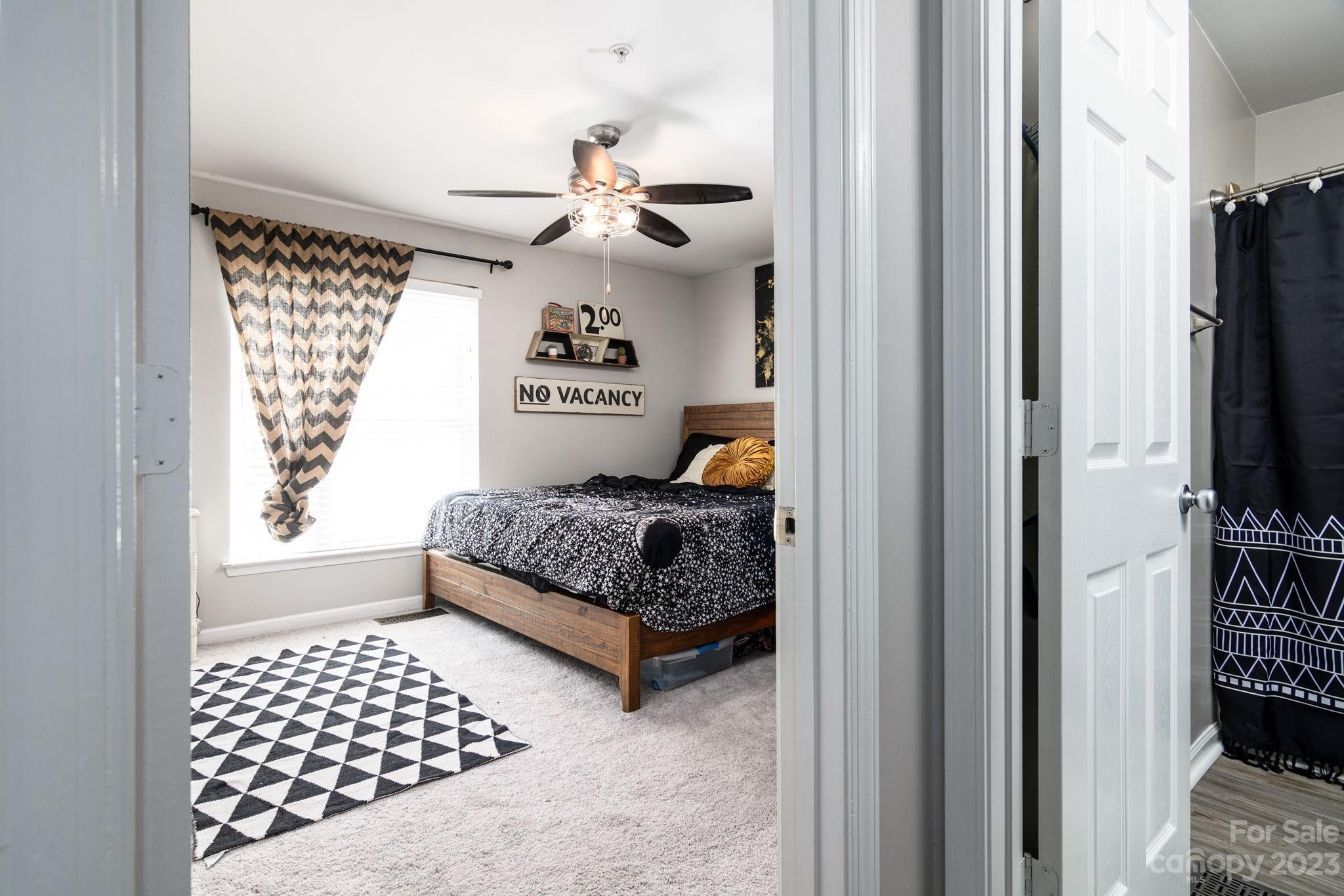 615 Raphael Place Charlotte, NC 28205 - Photo 9 of 20 a bedroom with a bed and wooden floor