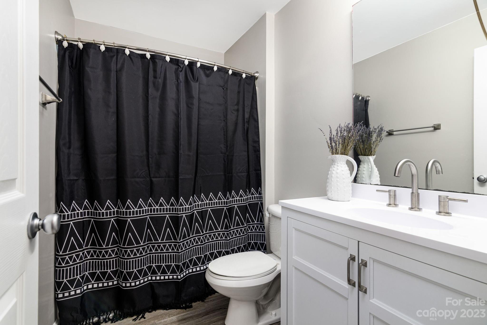 615 Raphael Place Charlotte, NC 28205 - Photo 10 of 20 a bathroom with a sink toilet and shower