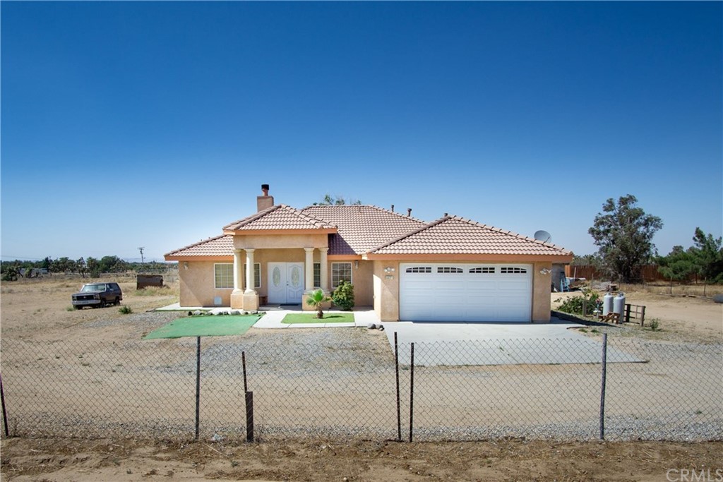 5922 Smoke Tree Road Phelan, CA 92371 - Photo 1 of 1 a front view of a house with a garden