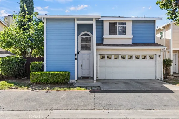 a view of a house with a yard and garage