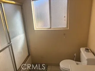 a white toilet sitting next to a window