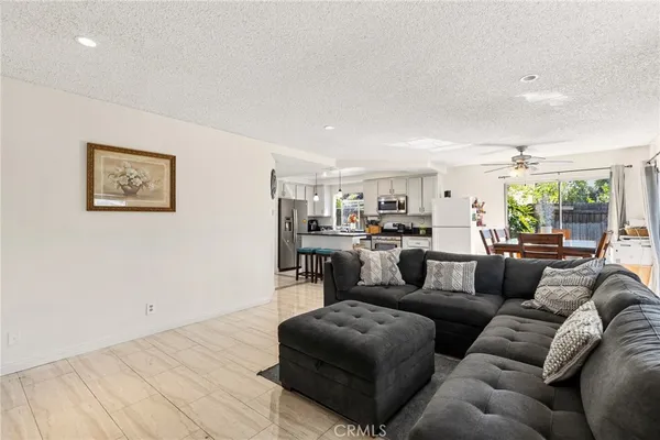 a kitchen with a refrigerator a microwave a stove and white cabinets