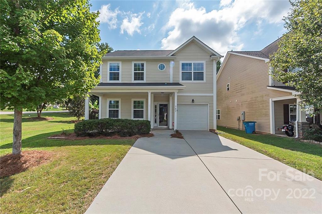 a front view of a house with a yard and garage
