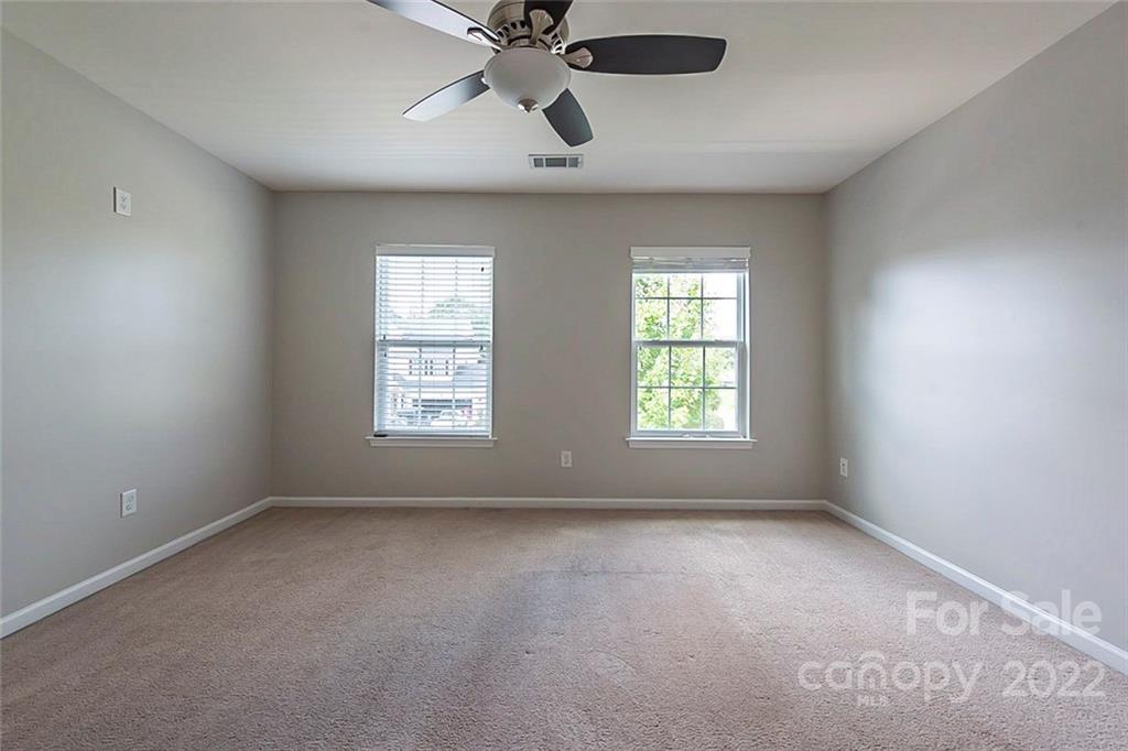 705 Jones Branch Road Fort Mill, SC 29715 - Photo 11 of 18 an empty room with windows and fan