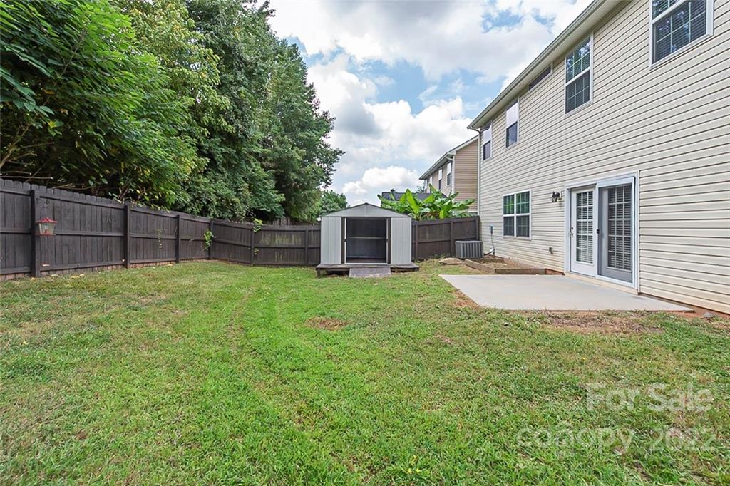 705 Jones Branch Road Fort Mill, SC 29715 - Photo 17 of 18 a view of a backyard with a barbeque grill and wooden fence