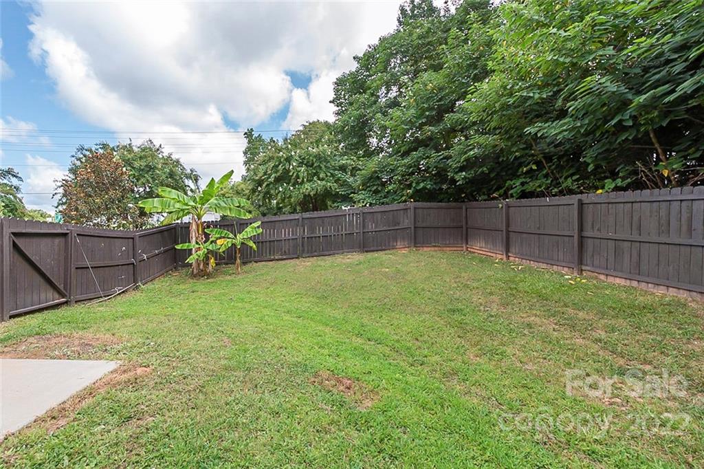 705 Jones Branch Road Fort Mill, SC 29715 - Photo 18 of 18 a view of a backyard with a garden and wooden fence