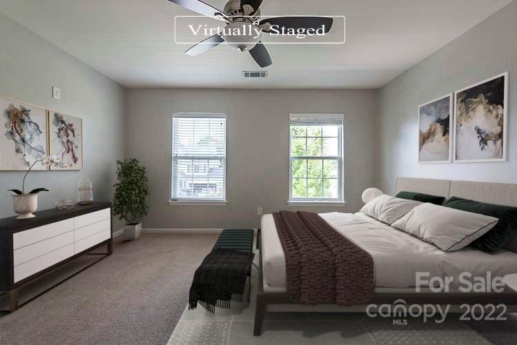 705 Jones Branch Road Fort Mill, SC 29715 - Photo 3 of 18 a bedroom with a bed and a chandelier