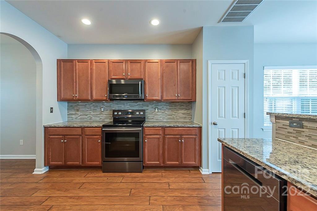 705 Jones Branch Road Fort Mill, SC 29715 - Photo 8 of 18 a kitchen with stainless steel appliances granite countertop a stove and a sink