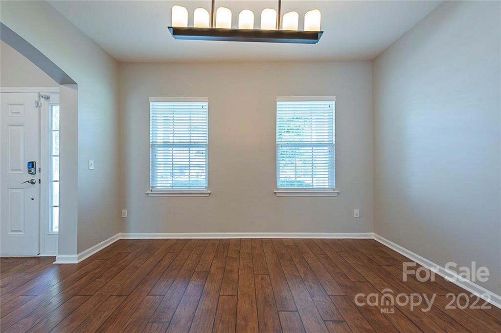 705 Jones Branch Road Fort Mill, SC 29715 - Photo 9 of 18 an empty room with wooden floor and windows