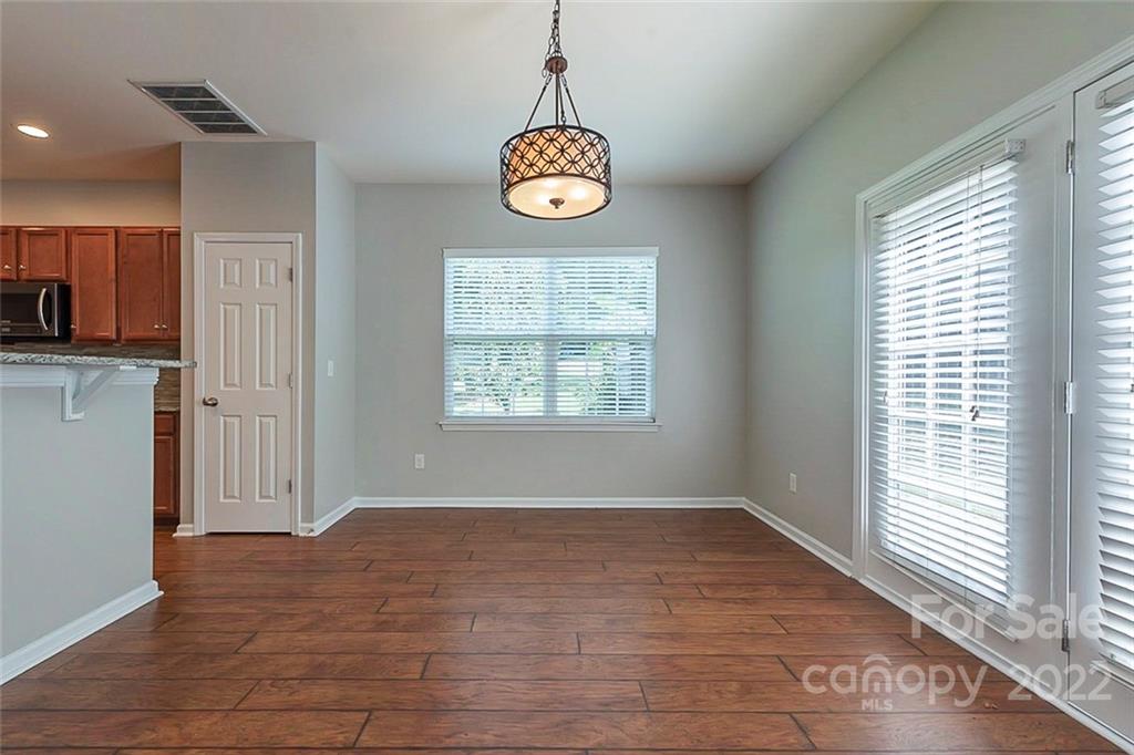 705 Jones Branch Road Fort Mill, SC 29715 - Photo 10 of 18 a view of an empty room with wooden floor and a window