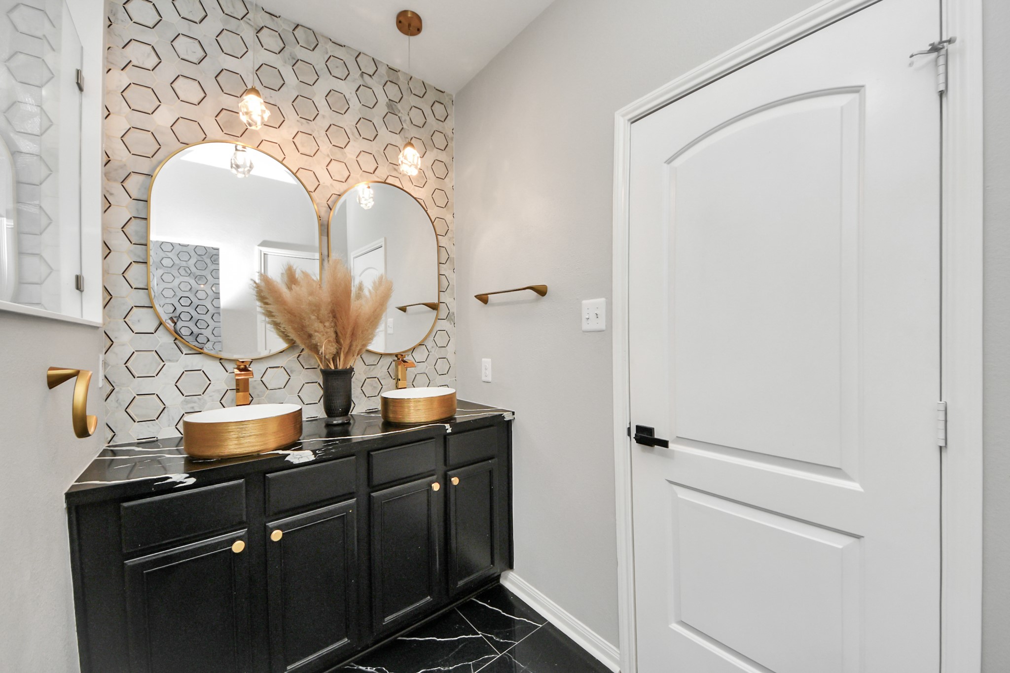 6931 Primrose Road Baytown, TX 77521 - Photo 22 of 50 Primary bath with dual vessel sinks, gold fixtures, and stylish hexagon tile accent wall.