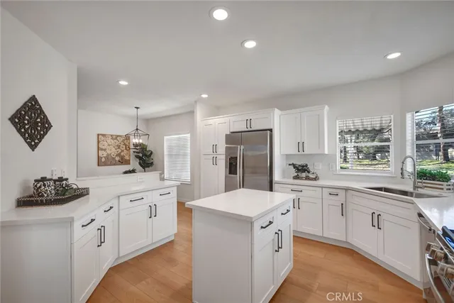 a kitchen with a sink stove and refrigerator