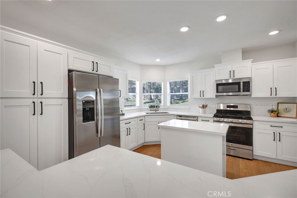 8651 Foothill Boulevard, Unit 42 Rancho Cucamonga, CA 91730 - Photo 15 of 39 a kitchen with stainless steel appliances granite countertop a refrigerator sink and stove