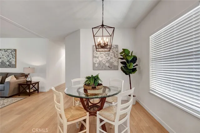 a dining room with furniture and potted plant