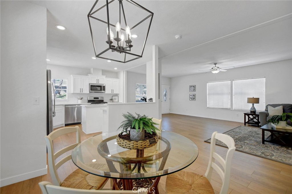 8651 Foothill Boulevard, Unit 42 Rancho Cucamonga, CA 91730 - Photo 20 of 39 a view of a dining room with furniture a kitchen and chandelier