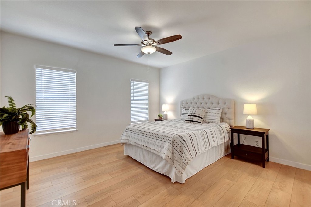 8651 Foothill Boulevard, Unit 42 Rancho Cucamonga, CA 91730 - Photo 21 of 39 a bedroom with a bed and a chandelier