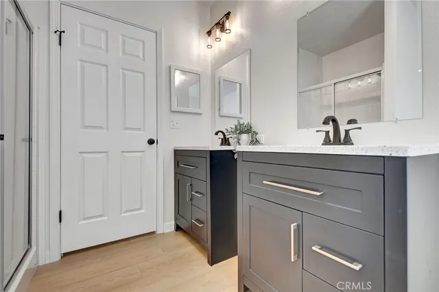 a kitchen with a sink vanity and mirror