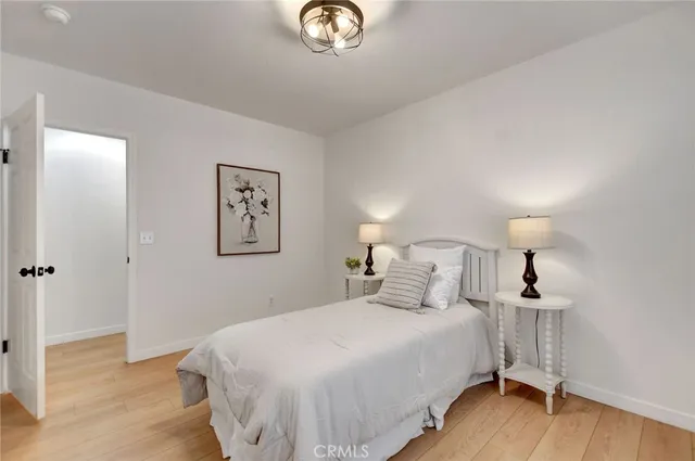 a bedroom with a bed and a lamp