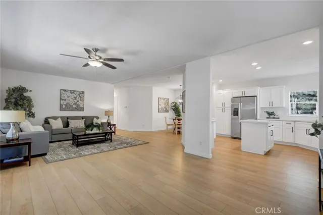 a view of a living room kitchen and a wooden floor
