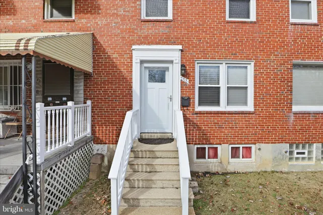 a front view of a house with wooden fence