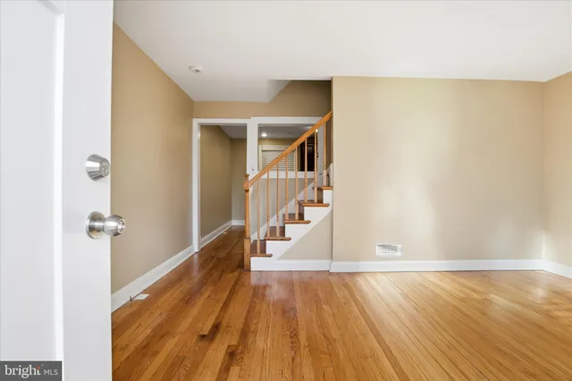 a view of a room with wooden floor and staircase