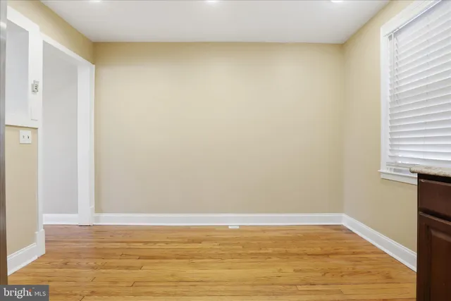 a view of a room with wooden floor and a window